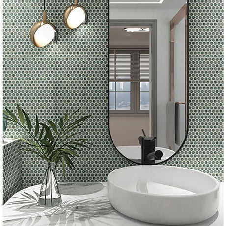 Bathroom interior with a round white sink, Penny Round Porcelain Mosaic Tile - Tropical Lush and a large mirror.