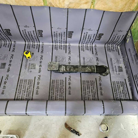 Coda Shower drain relocator installed with vinyl waterproofing in shower