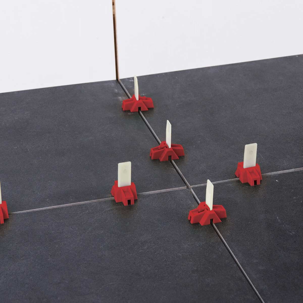 Tile lippage control spacers for floor and wall tile