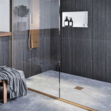 Modern shower with glass door, tiled walls, and a bench with a towel and Ebbe Square Shower Drain Grates Matte Black PVD 