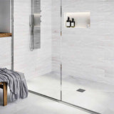Modern bathroom with glass shower enclosure, White wall tiles, and Polished Chrome fixtures with Ebbe Drains Unique Square Shower Drain Grate - Parallel