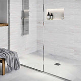 Modern bathroom with glass shower enclosure, White wall tiles, and Polished Chrome fixtures with Ebbe Drains Unique Square Shower Drain Grate - Splash