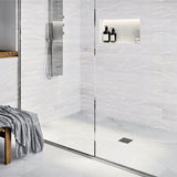 Modern bathroom with glass shower enclosure, White tiles, and gold fixtures with Ebbe Drains Unique Square Shower Drain Grate - Trend