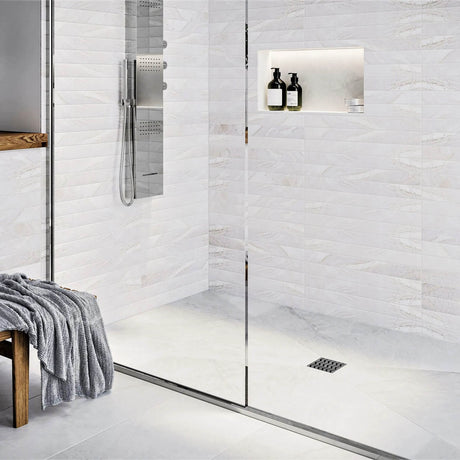 Modern bathroom with glass shower enclosure, White tiles, and gold fixtures with Ebbe Drains Unique Square Shower Drain Grate - Trend