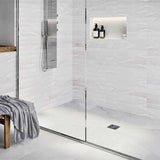 Modern bathroom with glass shower enclosure, White wall tiles, and Polished Chrome fixtures with Ebbe Drains Unique Square Shower Drain Grate - Twister
