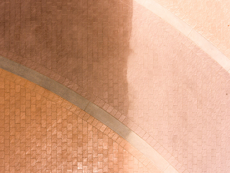 Close-up of a textured surface half been use with Glaze n Seal Enhanced Look Paver Sealer Locks-In Sand Joints