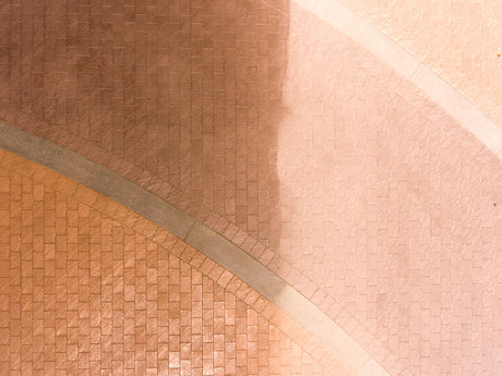 Close-up of a textured surface half been use with Glaze n Seal Enhanced Look Paver Sealer Locks-In Sand Joints