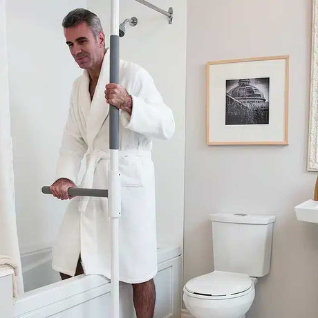 Mobility assistance pole with rotating support arm in residential bedroom