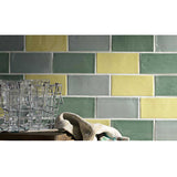 Green ceramic backsplash tile bringing natural color and style to a modern kitchen