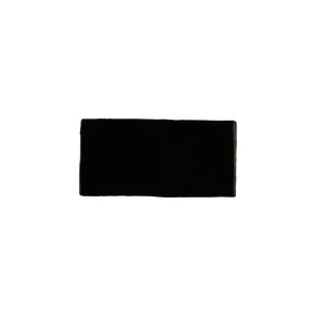 Glossy black ceramic subway tile with handcrafted Spanish artisan appeal