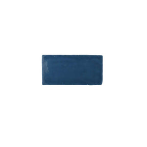 Handcrafted glossy blue ceramic wall tile with artisan-inspired texture