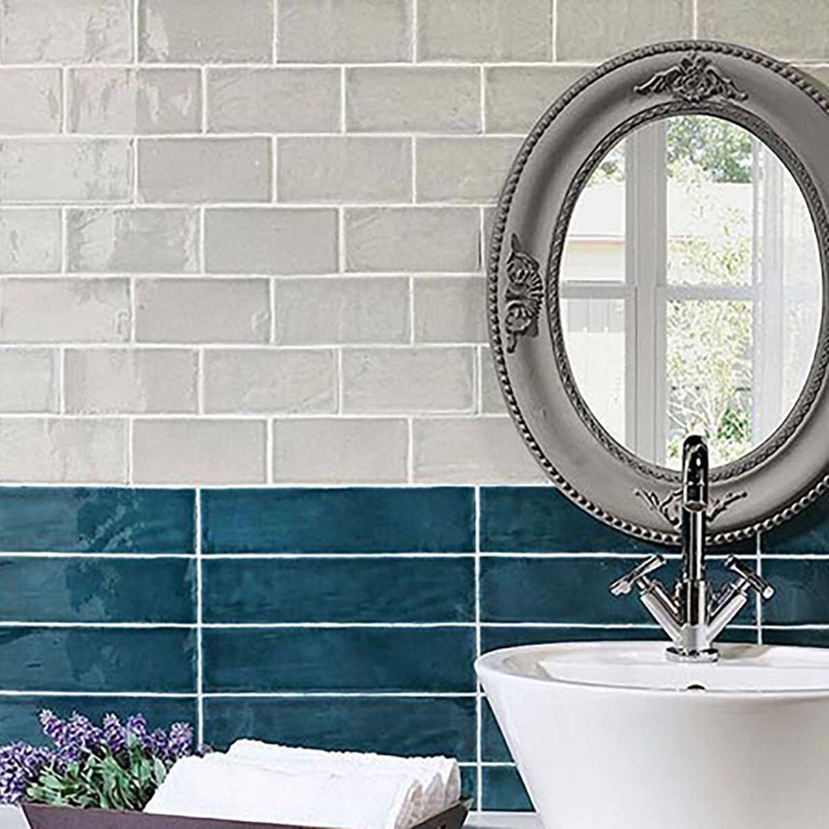 Blue ceramic subway tile backsplash in a modern kitchen with glossy finish