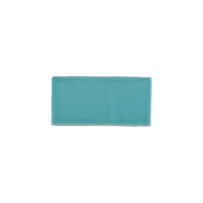 Glossy turquoise blue ceramic subway tile with handcrafted Spanish artisan texture
