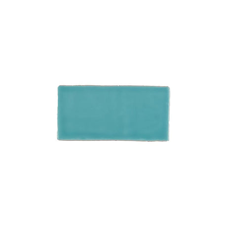 Glossy turquoise blue ceramic subway tile with handcrafted Spanish artisan texture