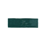 Glossy green ceramic wall tile with artisan-inspired handcrafted texture