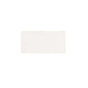 Glossy cream ceramic subway tile featuring handcrafted Spanish artisan texture