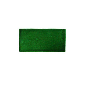 Glossy emerald ceramic subway tile featuring handcrafted Spanish artisan texture