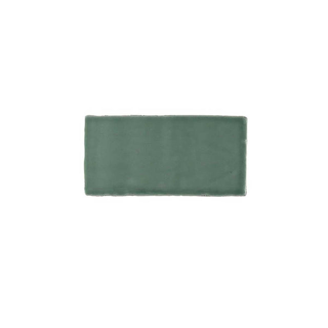 Glossy green ceramic subway tile featuring handcrafted Spanish artisan texture