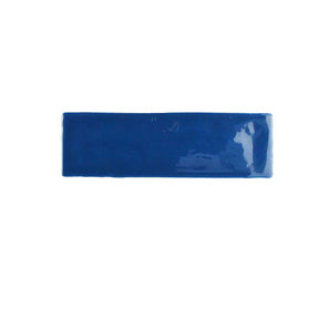 Glossy indigo ceramic wall tile with handcrafted Spanish artisan character