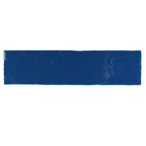 Glossy indigo ceramic subway tile with handcrafted Spanish artisan detailing