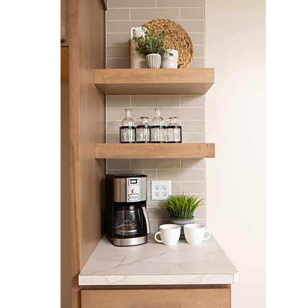 Small kitchenette with wooden shelves, coffee maker, and decor items.
