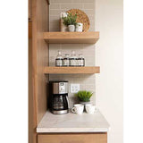 Small kitchenette with wooden shelves, coffee maker, and decor items.