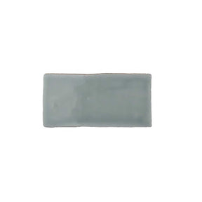 Glossy mint ceramic subway tile featuring handcrafted Spanish artisan texture