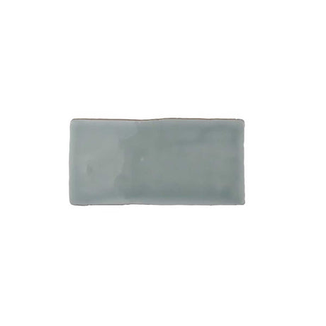 Glossy mint ceramic subway tile featuring handcrafted Spanish artisan texture