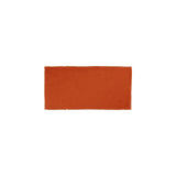 Glossy orange ceramic subway tile with handcrafted Spanish artisan detailing