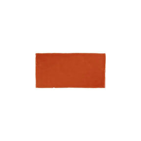 Glossy orange ceramic subway tile with handcrafted Spanish artisan detailing