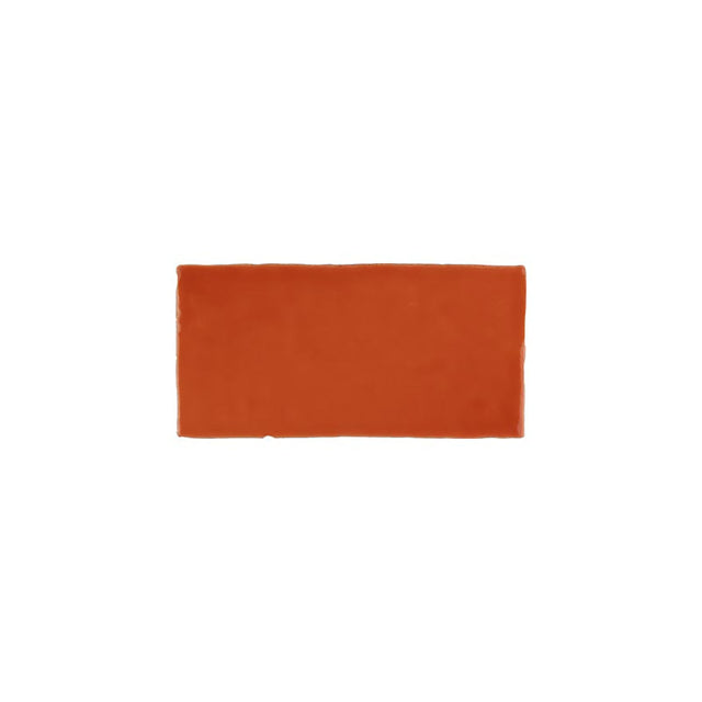 Glossy orange ceramic subway tile with handcrafted Spanish artisan detailing