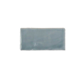 Glossy sky blue ceramic subway tile featuring handcrafted Spanish artisan texture