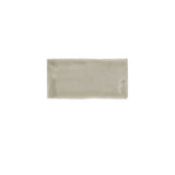 Glossy taupe ceramic subway tile featuring handcrafted Spanish artisan texture