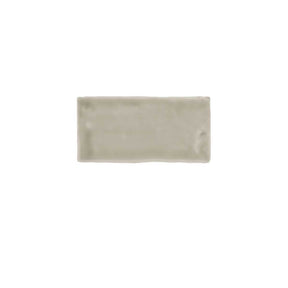 Glossy taupe ceramic subway tile featuring handcrafted Spanish artisan texture