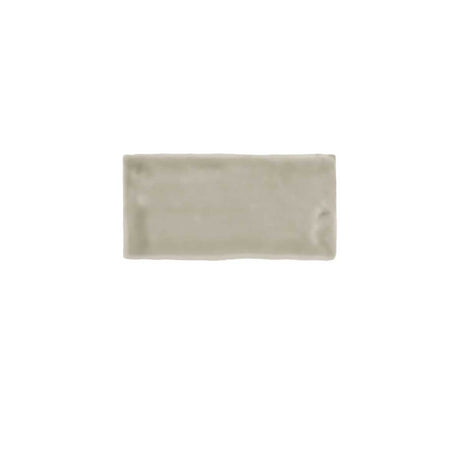 Glossy taupe ceramic subway tile featuring handcrafted Spanish artisan texture