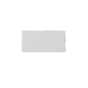 Glossy white ceramic subway tile featuring handcrafted Spanish artisan texture