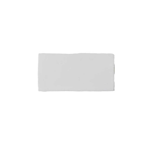 Glossy white ceramic subway tile featuring handcrafted Spanish artisan texture