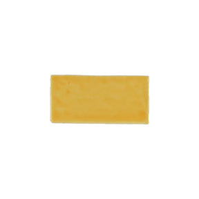 Glossy yellow ceramic subway tile with handcrafted Spanish artisan detailing