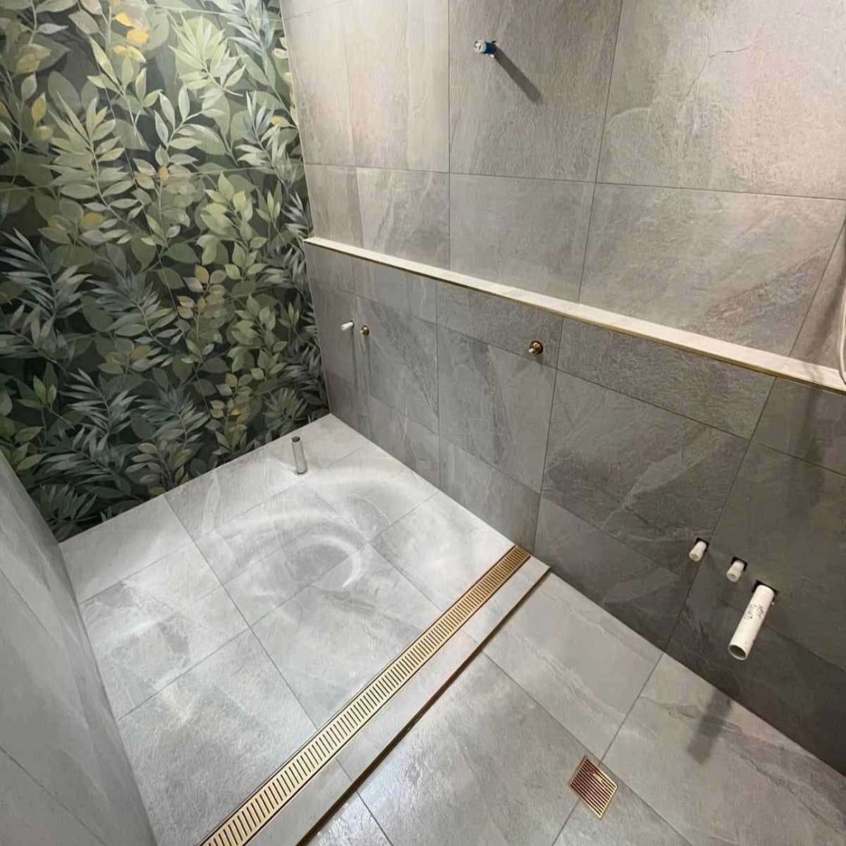 Lauxes Grates Custom Linear Shower Drain NeXT Generation - Matte Gold Installed in a walk in shower