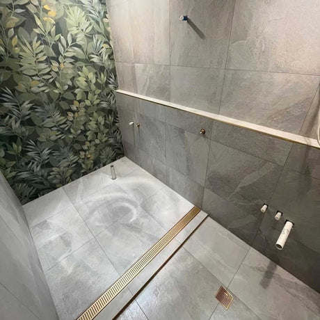 Lauxes Grates Custom Linear Shower Drain NeXT Generation - Matte Gold Installed in a walk in shower