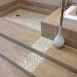 Natural river rock tile installed in a luxury walk in shower