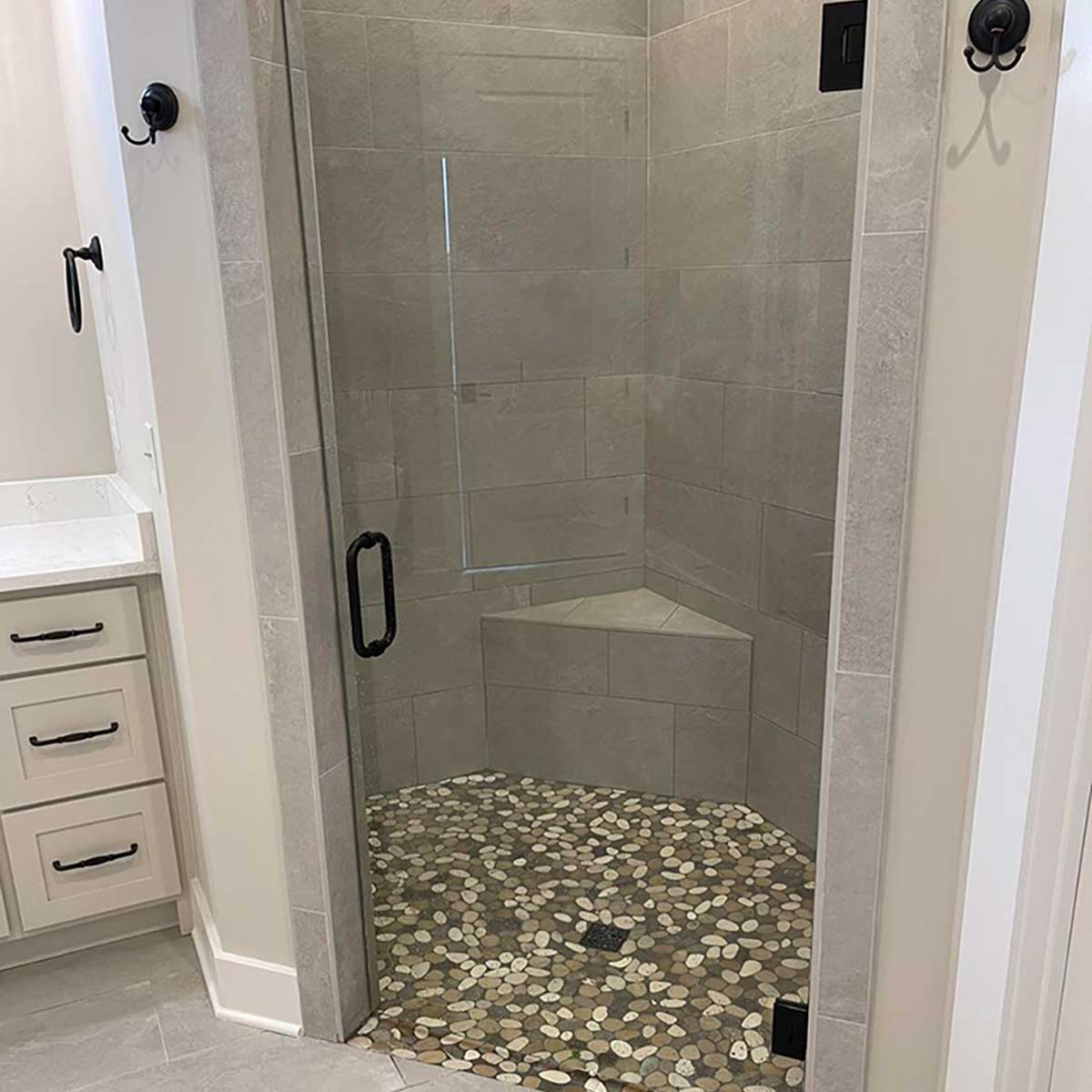Custom shower bench installed in tiled walk-in shower enclosure