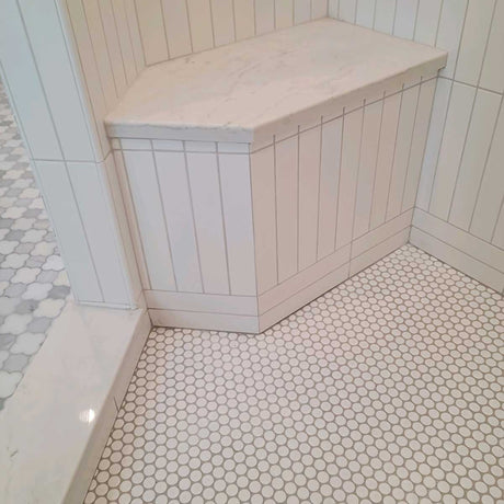 Waterproof shower seat integrated into tiled shower wall for comfortable seating