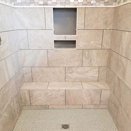 Installed ready-to-tile shower bench with custom tile finish in modern walk-in shower