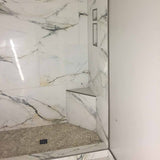 Marble-patterned shower enclosure with tiled walls and floor where the PreFormed Ready to Tile Shower Pan 