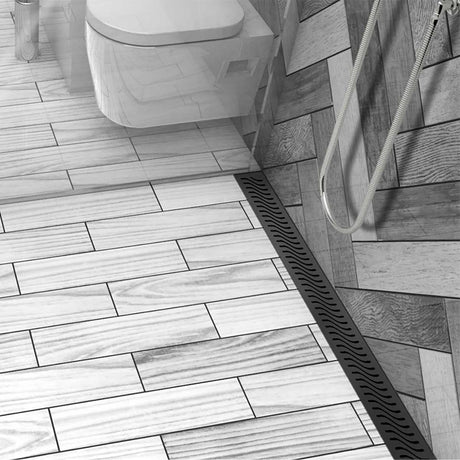 ACO Quartz stainless steel linear shower drain with Flag curved slot grate