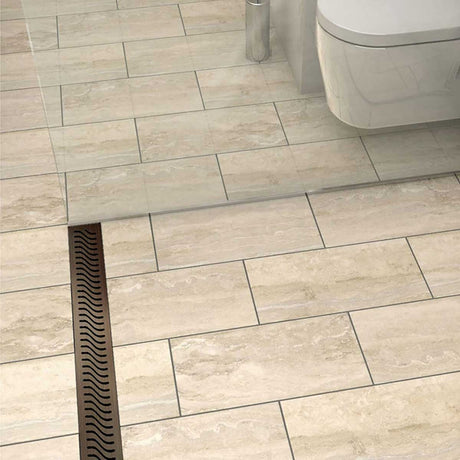 QuARTz Linear Shower Drain with Flag Grate - Oil Rubbed Bronze next to red flip flop in shower floor