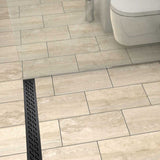 Quartz Hawaii stainless steel linear shower drain with curved slot pattern