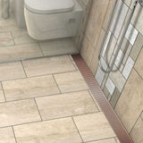 Rose Gold linear shower drain with foot-friendly wedge grate