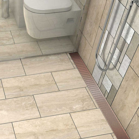 Rose Gold linear shower drain with foot-friendly wedge grate